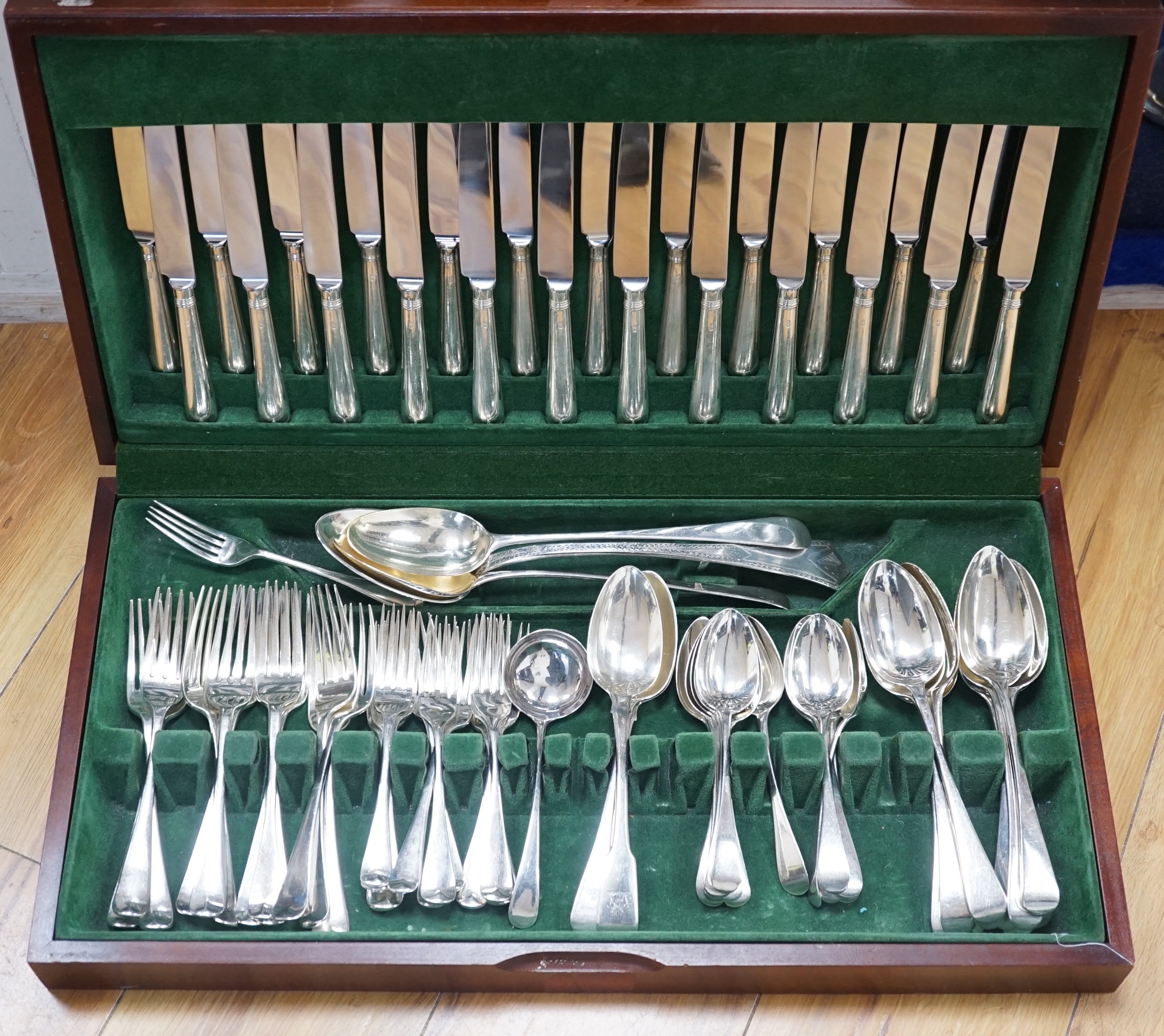 A part canteen of mainly 19th century and later silver cutlery, various patterns, dates and makers, comprising seventy eight items including modern table knives and one plated dessert fork, in a fitted wooden canteen